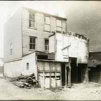 Sepia-tone photos, 4, of an old wood framed building on site of R. Neumann & Co., Hoboken, n.d., ca. 1917-1918.