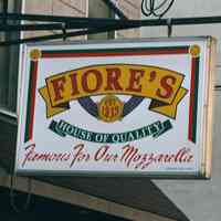 Color photo of hanging sign for Fiore