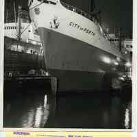 Black-and-white photo of S.S. City of Perth with damaged bow berthed at Bethlehem Steel Shipyard, Hoboken, May 8, 1963.