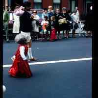 Color slide of a child walking in a parade.