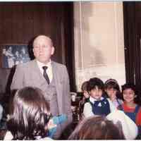 Digital image of color photo of Mayor Steve Cappiello in his City Hall Office with school children, Hoboken, 1984.