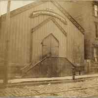 Sepia tone photo of First Baptist Mission Sabbath School exterior, south side of 2nd St. west of Clinton St., Hoboken, n.d., ca.1890-1897.