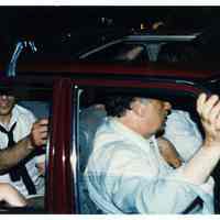 Color photo of mayoral candidate Tom Vezzetti in front seat of car on election night, Hoboken, [June 11, 1985].