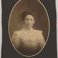 Sepia-tone photo of young woman posed in photographer