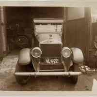 Sepia-tone photo of automobile parked facing out of a garage, location unknown, Hoboken, n.d., probably 1928.