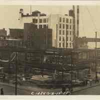 Sepia-tone photo of steel frame erection on the site for the Fabian Theatre, southeast corner of Newark & Washington Sts., Hoboken, Feb. 15, 1928.