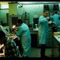 Color slide of four men in a lab.