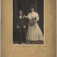 Sepia-tone photo of an unidentified bride and groom posed in a photo studio, Hoboken?, no date, ca. 1900-1910.