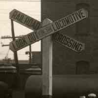          detail left: railroad crossing sign; Look Out for the Locomotive
   