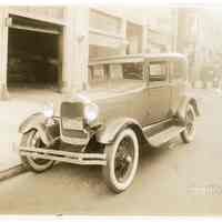 Sepia-tone photos, 2, of passenger automobile outside Model Garage, 208-214 Clinton St., Hoboken, Oct. 18, 1929.