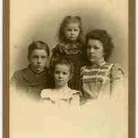 Cabinet photo of 4 children posed in photographer