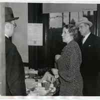 B+W photo of Eleanor Hartmann in office of murdered Overseer of the Poor Harry L. Barck, Hoboken City Hall, with Prosecutor Martin Faber & Police Detective Peter Smith, Feb. 25, 1938.