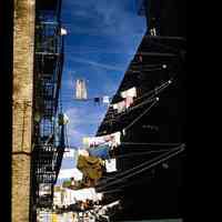 Color slide of laundry hanging between buildings.