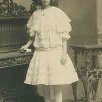 Sepia-tone photo of Florence Miller posed in studio of William Manewal, Hoboken, no date.