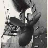 B+W photo of MV Grand Justice with repaired rudder & prop in dry dock at Bethlehem Steel Shipyard, Hoboken, n.d., April-May 1975.