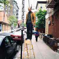          Three digital images: Artist Robert Burczy installing 'Burczy pole' (tube) with his Burczy posters on Third St. west of Bloomfield St., Hoboken, 2003. picture number 3
   