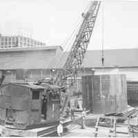 B+W photo of a funnel section of the S.S. Santa Cruz suspended from a crane, Hoboken, June, 1942.