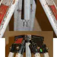          side view of mounting flange; screw tightening knob; plumb bob hook
   
