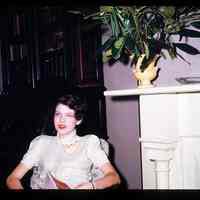 Color slide of a women sitting by the fire place in Anita Heimbruch