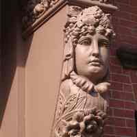 Digital images, 2, of details of pair of figural corbels near entry to unidentified building, Hoboken, August 27, 2004.