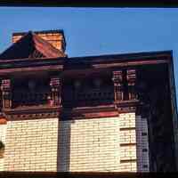 Color slide of detail view of chimney, pediment, cornice, brackets, window head and brick quoins at an unidentified location