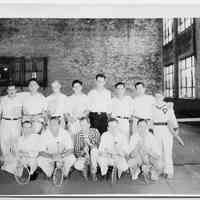 B+W group photo of a tennis team inside a shipyard building, Hoboken, no date, ca. 1930.