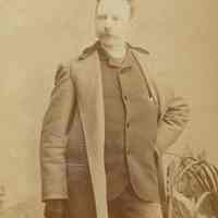 Digital image of sepia-tone standing photo portrait of painter Antonio Jacobsen, Brooklyn, N.Y., no date, ca. 1880-1890.