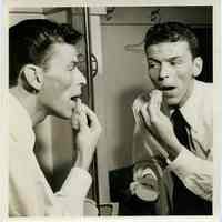 Sinatra photo: Frank Sinatra applying pancake make-up at dressing room mirror, n.p., n.d., ca. Oct. 13, 1944.