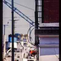 Color slide of detail view of frieze and fire escape at 1321 Washington on the SE corner with 14th looking E and a ship docked at the foot of 14th
