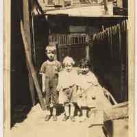 B+W photo of James & Lawrence Strehle; Gertrude Reilly as young children probably in 318 Clinton St. backyard, Hoboken, n.d., probably 1930-1936.