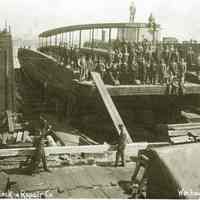 Sepia-tone photo of Union Dry Dock & Repair Co. workers repairing transfer car float barge No. 28 in dry dock, Weehawken, N.J., no date, ca. late 1920