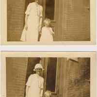 Sepia-toned photo of a woman and child outside 108 Tenth St.Bloomfield St., Hoboken, no date, probably 1924-1926.