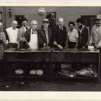 B+W photo of Steve Cappiello & 8 men at a hot dog roast, Hoboken, n.d, ca. 1983-1988.