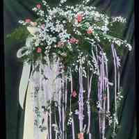 Lantern slide, color, of a floral arrangement on stand, used for promotional display in Hoboken, no date, ca. 1920.