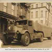 View of a Mack tanker truck in front of 150-152 Newark Street with Hoboken City Hall in background, Hoboken, circa 1943.