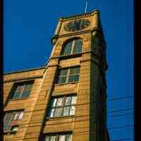          Color slide of close-up view of the clock tower at 300 Adams on the NW corner with 3rd formerly the Keuffel and Esser Manufacturing Complex picture number 1
   