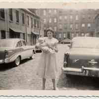 B+W photo of Joan Cunning holding Edward Cunning, Jr. in Willow Terrace South, Hoboken, 1957.