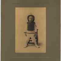 Sepia-tone photo of a boy posed in photographer