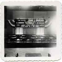 B+W photo of a hall decorated with political campaign sign & bunting by United Decorating Co. of Hoboken, Hoboken, 1953.