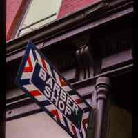          Color slide of close-up view of cornice and storefront signage reading 