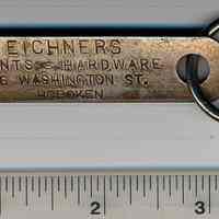 Tag, metal, with ring from Eichners Paints - Hardware, 216 Washington Street, Hoboken, no date, ca. 1900-1930.