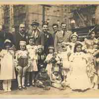 B+W photo of children in costume with 6 men at 5th & Jefferson Sts., Hoboken, n.d., ca. late 1940s.