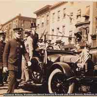 Sepia-tone photo of President Woodrow Wilson in motorcade on Washington St. between Newark & First Sts., Hoboken, July 8, 1919.