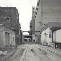 Digital image of B+W photo of former Maxwell House Coffee plant exterior, looking north between Extraction Building & Storage Silos, Hoboken, 2003.