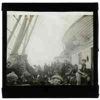 B+W lantern slide of Irish immigrants on deck of a ship, n.p. (U.K.), 1898.