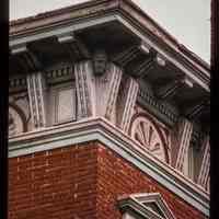 Color slide of detail view of cornice, brackets, dentils, frieze and window head pediment on the corner of Willow and 7th