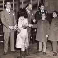 Digital image of b+w photo of Mayor Fred DeSapio (at right) greeting children at City Hall, Hoboken, no date, ca. 1947-1950.