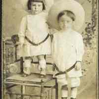 Sepia-tone photo of 2 young children posed in studio, Hoboken, n.d., ca. 1890-1910.