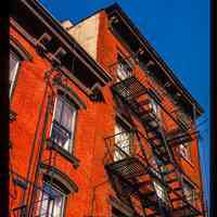          Color slide of detail view of row house façades, cornices and fire escapes on buildings at an unidentified location picture number 1
   