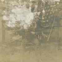 Sepia-tone photo, damaged, of "Grandpa" seated in a patriotic vignette, no place, no date, ca. 1885-1900.